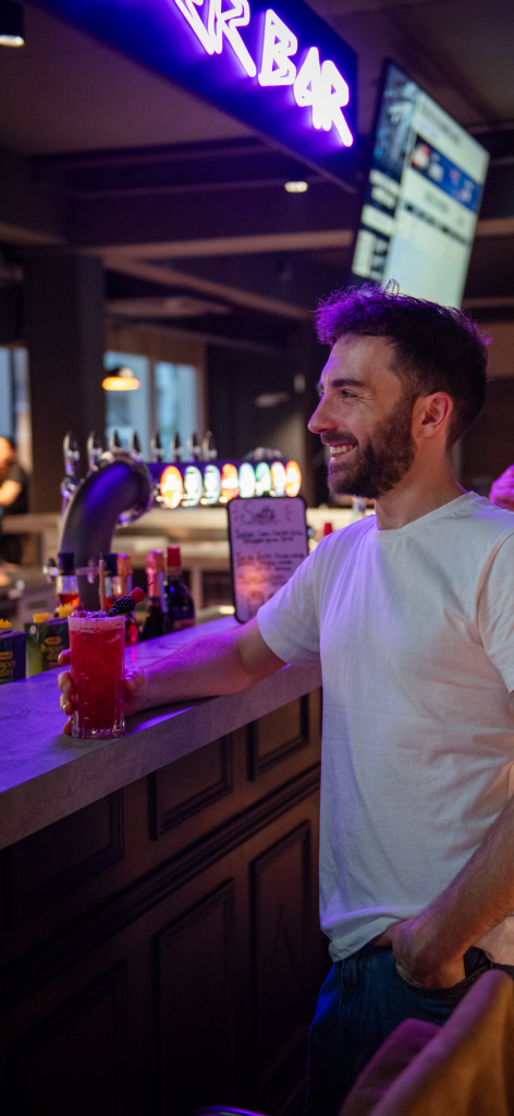 Un homme entrain de boire un cocktail au CyberBar de l'étage EVA